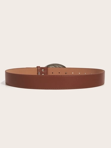 Detail of brown leather belt featuring embossed snake pattern silver buckle and metal rivets