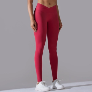 Detail view of red seamless high-waist yoga leggings with crossover V-cut waistband
