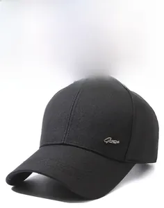 Dettaglio del berretto nero con trama in tessuto twill e logo laterale in metallo