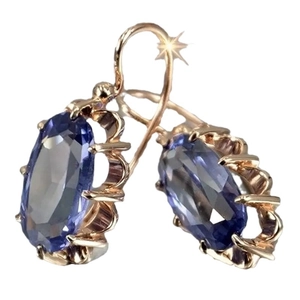 Elegant rose gold drop earrings with oval blue gemstones in a multi-prong setting