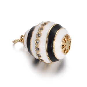 Detail of egg-shaped Evil Eye pendant with black enamel, rhinestones and gold plating