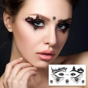 Detail of black spider web and pumpkin temporary eye tattoo for Halloween makeup