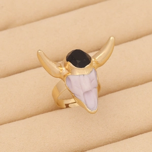 Detail of bohemian gold ox-head ring with black faceted gemstone in jewelry display