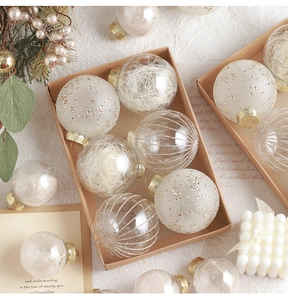 Detail of luxury champagne Christmas ball set with glitter and feathers in a gift box