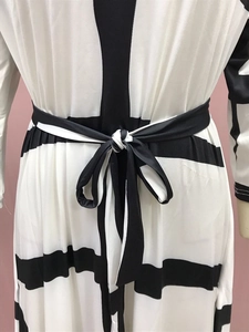 Detailed view of black and white geometric stripe dress with waist bow tie-up knot