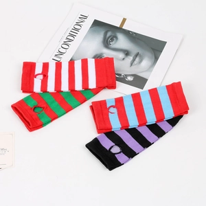 Detail of striped knitted arm warmers with thumb holes in various vibrant color patterns