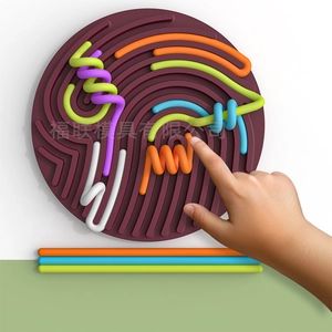 Detail of toddler hands using sensory activity board with colorful silicone strings