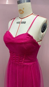 Detail view of pink corset dress showing glittering mesh fabric and bone support