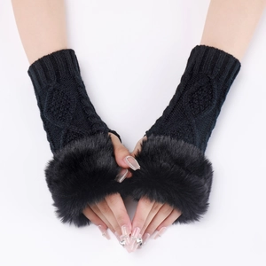 Close-up of black cable knit arm warmers with faux fur trim and fingerless design