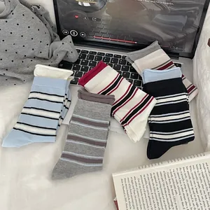 Detailed view of casual striped crew socks in various colors on a lifestyle background