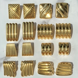 Detailed collection of 18K gold plated stainless steel geometric earrings on marble