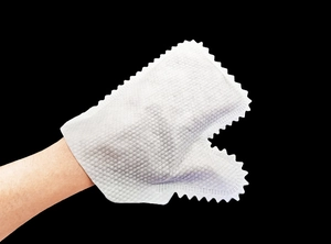 Macro view of white non-woven cleaning glove with diamond texture for kitchen use
