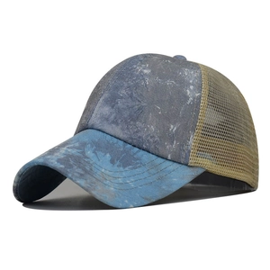 Detail of blue washed denim fabric and khaki breathable mesh on a baseball cap