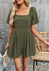 Detail view of olive green romper with square neck and pleated waist design