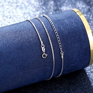 Close-up of silver box chain necklace with lobster clasp and adjustable extension chain