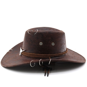Brown western cowboy hat in distressed leather with bull skull metal ornament and braided strap