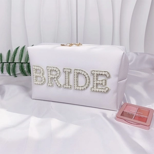 White bridal makeup bag with pearl rhinestone BRIDE lettering and gold zipper closure