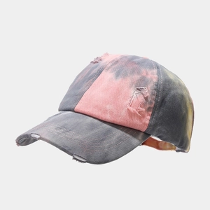 Macro detail of tie-dye baseball cap with vintage distressed ripped effects and frayed edges