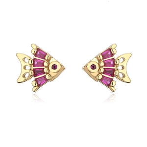 Macro detail of gold plated fish stud earrings with purple zircon and red stone
