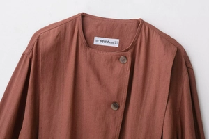 Close-up of reddish brown suede jacket with button placket and natural fabric texture