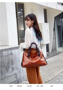Large capacity genuine leather shoulder bag, stylish commuter handbag for women daily wear.