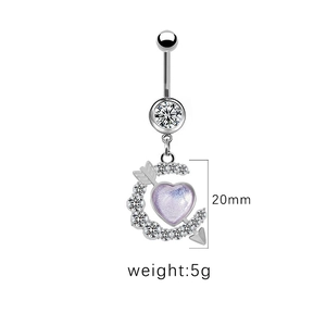 Macro view of silver moon navel piercing with purple heart crystal and 20mm size detail