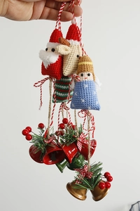 Detail of handmade crochet Santa Claus and reindeer charms with festive metal bells