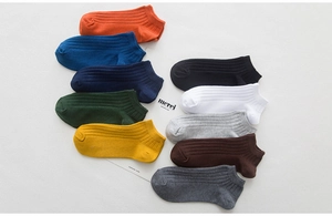 Flat lay of breathable cotton ankle socks in ten vibrant colors for men and women