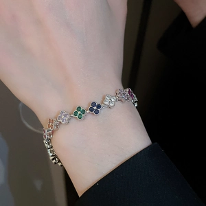 Detailed macro of a multi-color clover charm bracelet with sparkling zircon stones