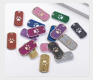 Macro shot of rectangular glitter alloy pet tags with hollow paw print for dog collars
