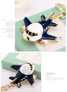 Macro view of blue and white A380 airplane keychain with rhinestones and gold accents