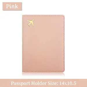 Pink lychee grain leather passport holder with a gold airplane icon and card slots
