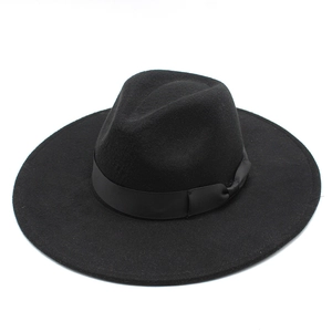 Close-up of a wide brim black wool fedora featuring a decorative matching satin ribbon