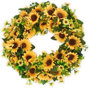 Detail of vibrant yellow silk sunflower wreath with dense green leaves on white background