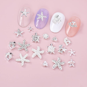 Silver ocean themed nail charms with starfish, shells and pearls for summer manicures