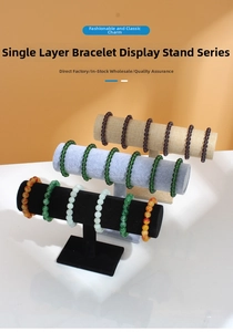 Detailed view of T-bar bracelet stands in velvet and linen with stable rectangular bases