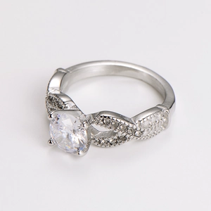 Macro detail of stainless steel ring featuring infinity band design and zircon accents