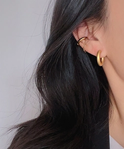 Close-up of matte 18k gold plated hoop earring and chain ear cuff on female model