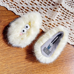 Cute plush hair clips with cartoon big eyes and metal duckbill pins on lace background