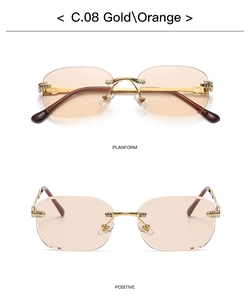 Detail view of rimless square sunglasses with gold metal frame and orange tinted lenses