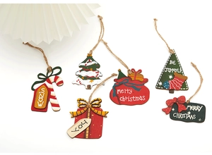 Miniature wooden Christmas tree ornaments with festive red and green printed designs