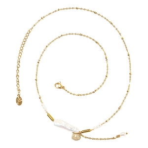 Elegant gold chain baroque pearl necklace with sunburst pendant on white background