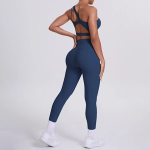 Deep blue two-piece yoga set with one-shoulder sports bra and high-waist leggings