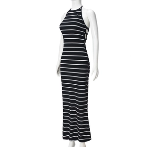 Detail of the side lace-up cutout on a black and white striped halter maxi dress