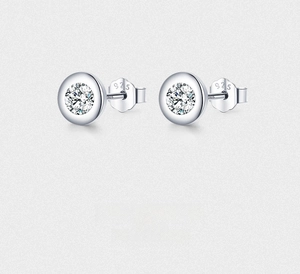 Macro shot of S925 sterling silver stamp and sparkling round cubic zirconia stud earrings