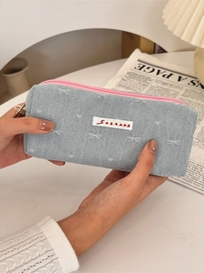 Blue denim pencil case with pink zipper and bow design, portable stationery storage bag
