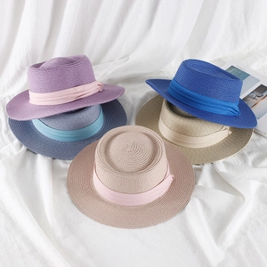 Detailed top view of assorted colorful woven straw sun hats with elegant ribbon bands