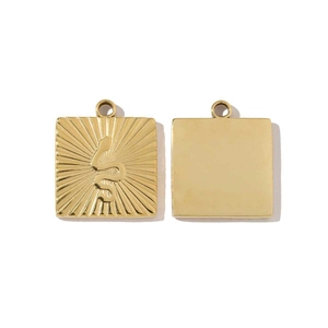 Detailed view of square gold titanium steel pendants with snake and sunburst relief texture