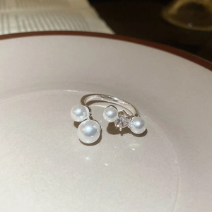 Detail of silver adjustable ring with white pearls and sparkling cubic zirconia stones