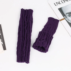 Detailed close-up of dark purple knit arm warmers featuring a classic cable stitch texture